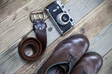 Image showing sturdy brown boots, leather belt, and rangefinder camera