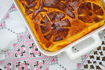 Image showing cabbage pie on the embroidered cloth. Russian cuisine