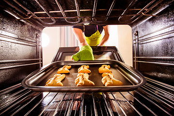 Image showing Baking Gingerbread man in the oven