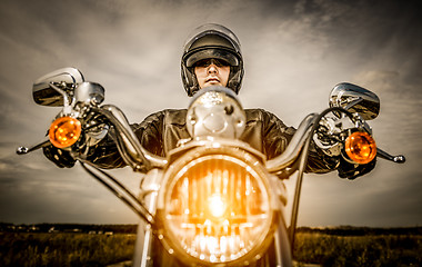 Image showing Biker racing on the road