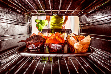 Image showing Baking muffins in the oven