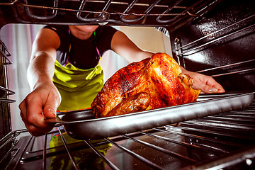 Image showing Cooking chicken in the oven at home.