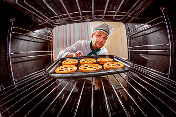 Image showing Chef cooking in the oven.