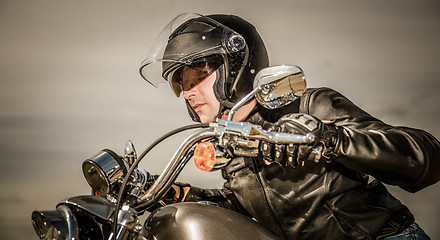 Image showing Biker racing on the road