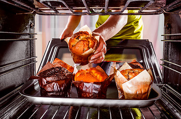 Image showing Baking muffins in the oven