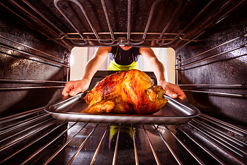 Image showing Cooking chicken in the oven at home.