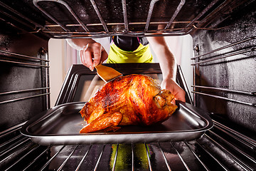 Image showing Cooking chicken in the oven at home.