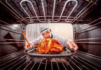 Image showing Cooking chicken in the oven.