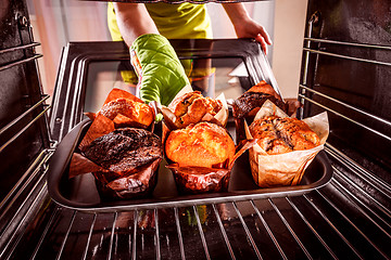 Image showing Baking muffins in the oven