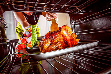 Image showing Cooking chicken in the oven at home.