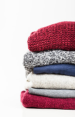 Image showing Stack of handmade wool sweaters