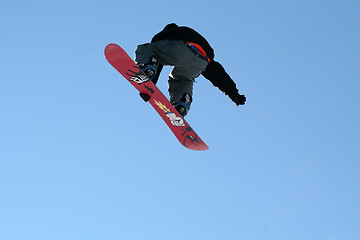 Image showing Snowboarder jumping high