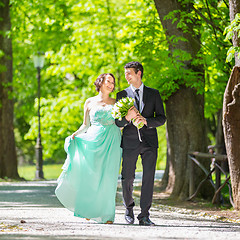 Image showing Wedding couple walking in park.