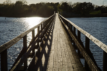 Image showing Backlit footbridge