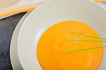 Image showing Orange pumpkin cream soup and green onion