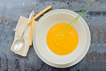 Image showing Delicious healthy pumpkin soup, spoon and napkin