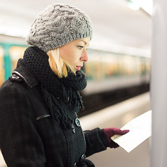 Image showing Lady looking on public transport map panel.