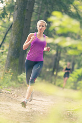 Image showing Pretty young girl runner in the forest. 