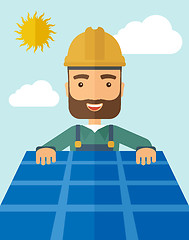 Image showing Man putting a solar panel on the roof.