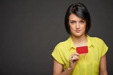 Image showing Confident woman showing blank credit card