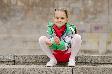 Image showing Six-year girl sits on the granite steps