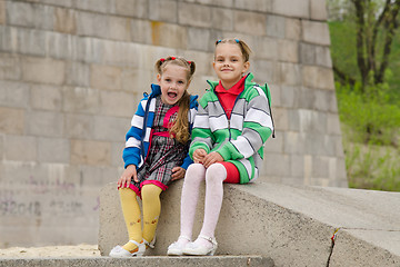 Image showing Two girls sit on a granite staircase