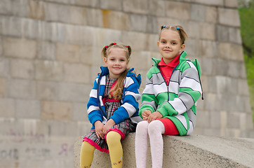 Image showing Sisters sitting on a granite ramp