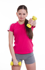 Image showing Sportswoman raised her left arm with a dumbbell