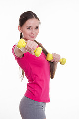 Image showing Beautiful athlete holding a dumbbell at arm\'s length