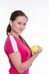 Image showing Sportswoman with dumbbells inflates his right hand