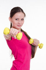 Image showing Sportswoman with two dumbbells in the hands of