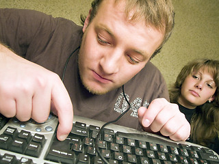 Image showing The mad programmer with the keyboard. A funny picture