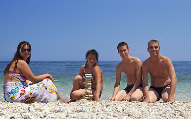 Image showing Family at beach built the piramyd