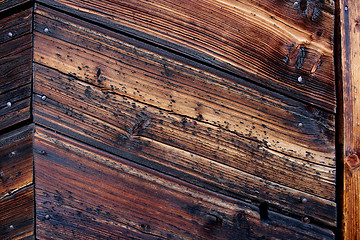 Image showing Very old weather beaten door in brownish colours.