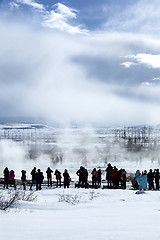 Image showing Visitors watching the eruption of a geyser in Iceland