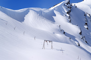 Image showing Old surface lift and mountains with snow cornice