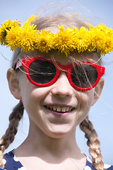 Image showing smiling girl in sunglasses and dandelion garland