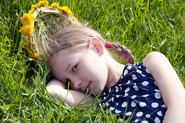 Image showing young girl lying on green grass