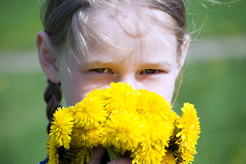 Image showing girl\'s face with yellow dandelions