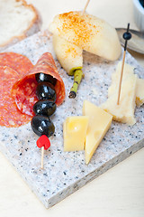 Image showing mix cold cut on a stone with fresh pears