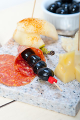 Image showing mix cold cut on a stone with fresh pears