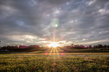 Image showing Sunset over green farm field 