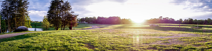 Image showing Sunset over green farm field 