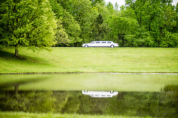 Image showing white limo reflecting in lake