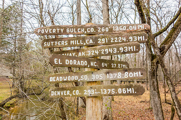 Image showing wooden direction sign in the forest