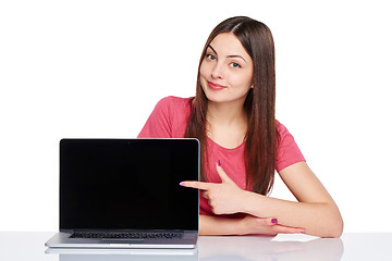 Image showing Happy woman pointing at a laptop computer screen