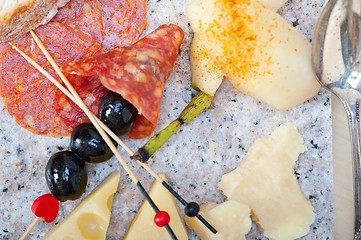 Image showing mix cold cut on a stone with fresh pears