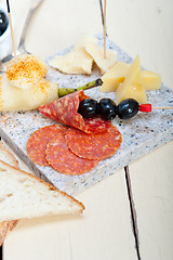 Image showing mix cold cut on a stone with fresh pears