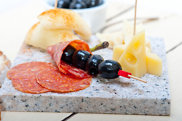 Image showing mix cold cut on a stone with fresh pears