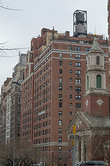 Image showing Water tower by a church